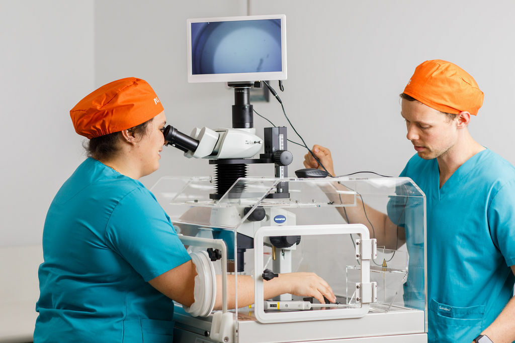 Embryologist combining sperm and egg in the IVF process